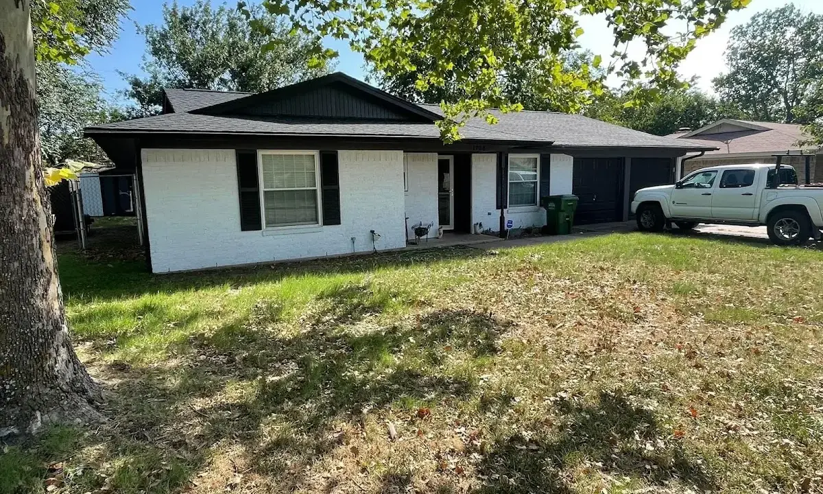 Professional roofing crew working on a residential roof in East Huntingdon
